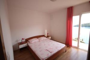 Postel nebo postele na pokoji v ubytování Apartments Antunović