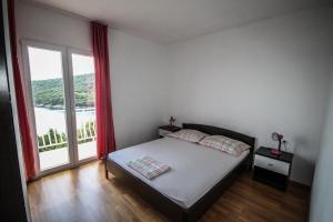 Postel nebo postele na pokoji v ubytování Apartments Antunović