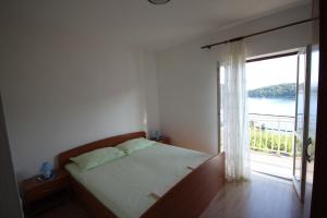 Postel nebo postele na pokoji v ubytování Apartments Antunović