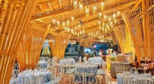 a large room with white tables and chairs and chandeliers at SPRING GARDEN HOTEL LK in Long Khanh +87 photos