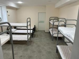 a room with several bunk beds in a hospital at Lighthouse in Aktau