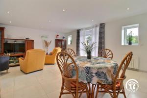 a dining room with a table and chairs at Longere du gaudin in Pluherlin