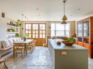a kitchen with a counter and a table and chairs at Chantry House in Shoreham-by-Sea