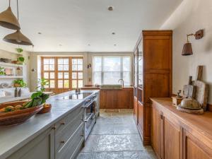 a large kitchen with a counter and a sink at Chantry House in Shoreham-by-Sea +21 photos