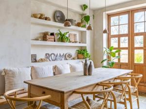 a dining room with a wooden table and chairs at Chantry House in Shoreham-by-Sea