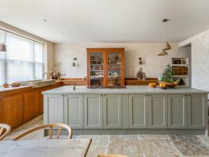 a kitchen with a large island in the middle at Chantry House in Shoreham-by-Sea
