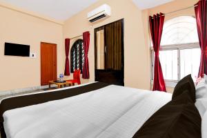 Postel nebo postele na pokoji v ubytování Super Hotel O NSCB International Airport Formerly Bougain Villa