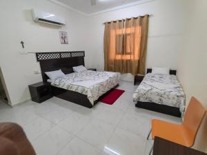 a bedroom with two beds and a window at Turtle Guest House in Sur +31 photos