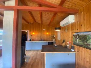 a large kitchen with wooden walls and wooden floors at Romantic Retreat Close To The Beach in Fårevejle