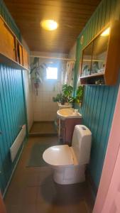 a bathroom with a toilet and a sink at Romantic Retreat Close To The Beach in Fårevejle +20 photos