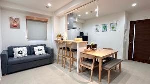 a living room with a couch and a table at Ansou house 大阪ドーム in Osaka