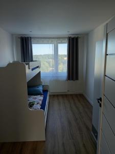 a small room with a bed and a window at Apartmán s 2 spálňami in Prievidza