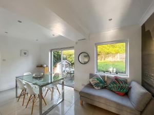 a living room with a glass table and a couch at Hamble Haven in Lower Swanwick