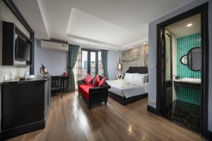 a hotel room with a bed and a red couch at Hanoi Indochine Premium Hotel in Hanoi +51 photos