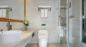 a bathroom with a toilet and a sink and a shower at Vienna Hotel Chengdu University of Pertroleum Metro Station in Chengdu +67 photos
