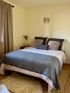 a bedroom with a bed with a black and white comforter at Refugi La Cerdanya, Ski and Pool La Cerdaña in Bourg-Madame +10 photos