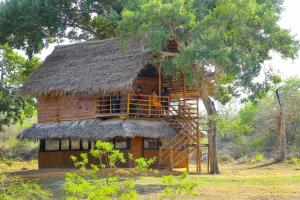 a tree house with a thatched roof at Nature Win Yala in Hambantota