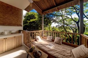 a room with a large window with a couch on a balcony at Wanan Tinglan Wild Luxury Resort Designer Hotel in Jinghong +137 photos