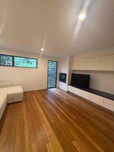 ein großes Wohnzimmer mit Sofa und TV in der Unterkunft 2 Bed- Beach and Bush Retreat- Yaroomba-Sunshine Coast in Yaroomba
