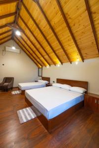 a bedroom with a large bed and a wooden ceiling at Sakun villa in Mirissa +26 photos