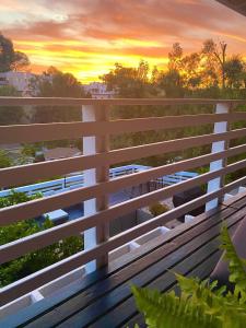 a sunset seen from the balcony of a building at Hillside Hideaway - Private Woodland Hills Canyon Suite in Woodland Hills