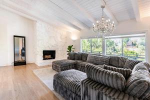 a living room with a couch and a fireplace at Hillside Hideaway - Private Woodland Hills Canyon Suite in Woodland Hills