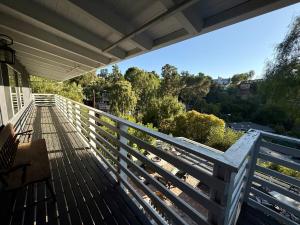a porch of a house with a white railing at Hillside Hideaway - Private Woodland Hills Canyon Suite in Woodland Hills