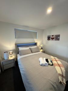 a bedroom with a large bed with two pillows on it at Green Hill Views - Family Home close to Hobart - 4bed, 2bath in Rokeby