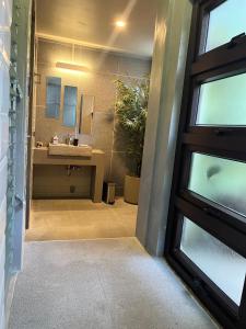 a bathroom with a sink and a mirror at Eliseos Bed & Kitchen in San Juan +34 photos