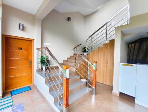 a staircase in a house with a wooden door at 88 GREEN FORT EDAPALLy in Ernakulam