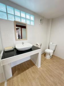 a bathroom with a sink and a toilet at De Hom Hotel Mae Hong Son in Mae Hong Son +21 photos