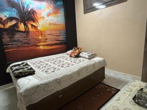 a bed in a room with a painting on the wall at Mato Shree Aashray Homestay in Gaya