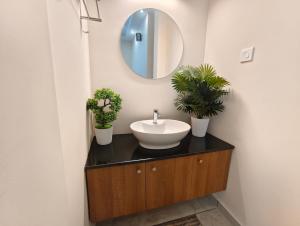 a bathroom with a sink and a mirror at 88 GREEN FORT EDAPALLy in Ernakulam +48 photos
