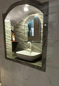a sink in a bathroom with a mirror at Mato Shree Aashray Homestay in Gaya