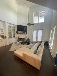 a large living room with a couch and a tv at Cute Home with some Razzle Dazzle in Baton Rouge