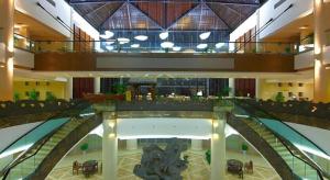 a large building with a lobby with tables and chairs at Huangshan Xuanyuan International Hotel in Huangshan