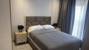 a bedroom with a large bed with two night stands at Metropoleparc luxury apparthotel in Casablanca