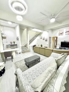 a large living room with a couch and a piano at The Hydrangea House in Kota Kinabalu