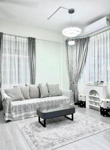 a living room with a couch and a coffee table at The Hydrangea House in Kota Kinabalu