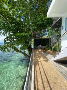 a view of the ocean from a balcony of a house at Villa Talisay Kaputian - Beach house in Samal