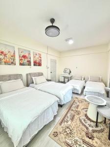 a room with three beds and a couch at The Hydrangea House in Kota Kinabalu +44 photos