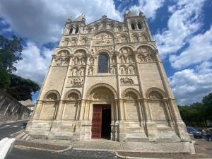 a church with a tall tower with a sky at The Little Robin in Chevanceaux