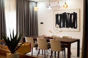 a dining room with a wooden table and chairs at Villa Hills Hotel 