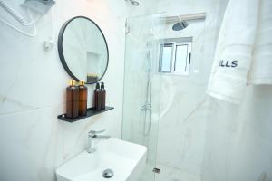 a white bathroom with a sink and a mirror at Villa Hills Hotel  +12 photos