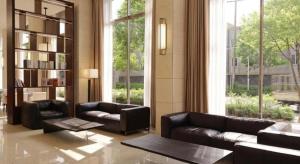 a living room with leather furniture and a large window at Top Cloud Hotel Iksan in Iksan