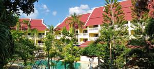 a resort with a swimming pool and palm trees at Successive BeachFront ,Krabi in Ban Khlong Haeng