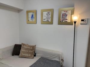 a room with a bed and four pictures on the wall at 板橋 RCアネックス Rc205 in Tokyo