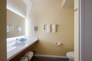a bathroom with a sink and a mirror at Inn at Port Gardner-Everett Waterfront, Ascend Hotel Collection in Everett +46 photos