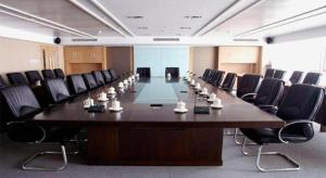 a large conference room with a long table and chairs at Tangshan Qiangang Hotel in Qian'an