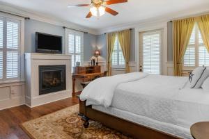 a bedroom with a bed and a fireplace at Inn at I'On, an Ascend Collection Hotel in Charleston +29 photos